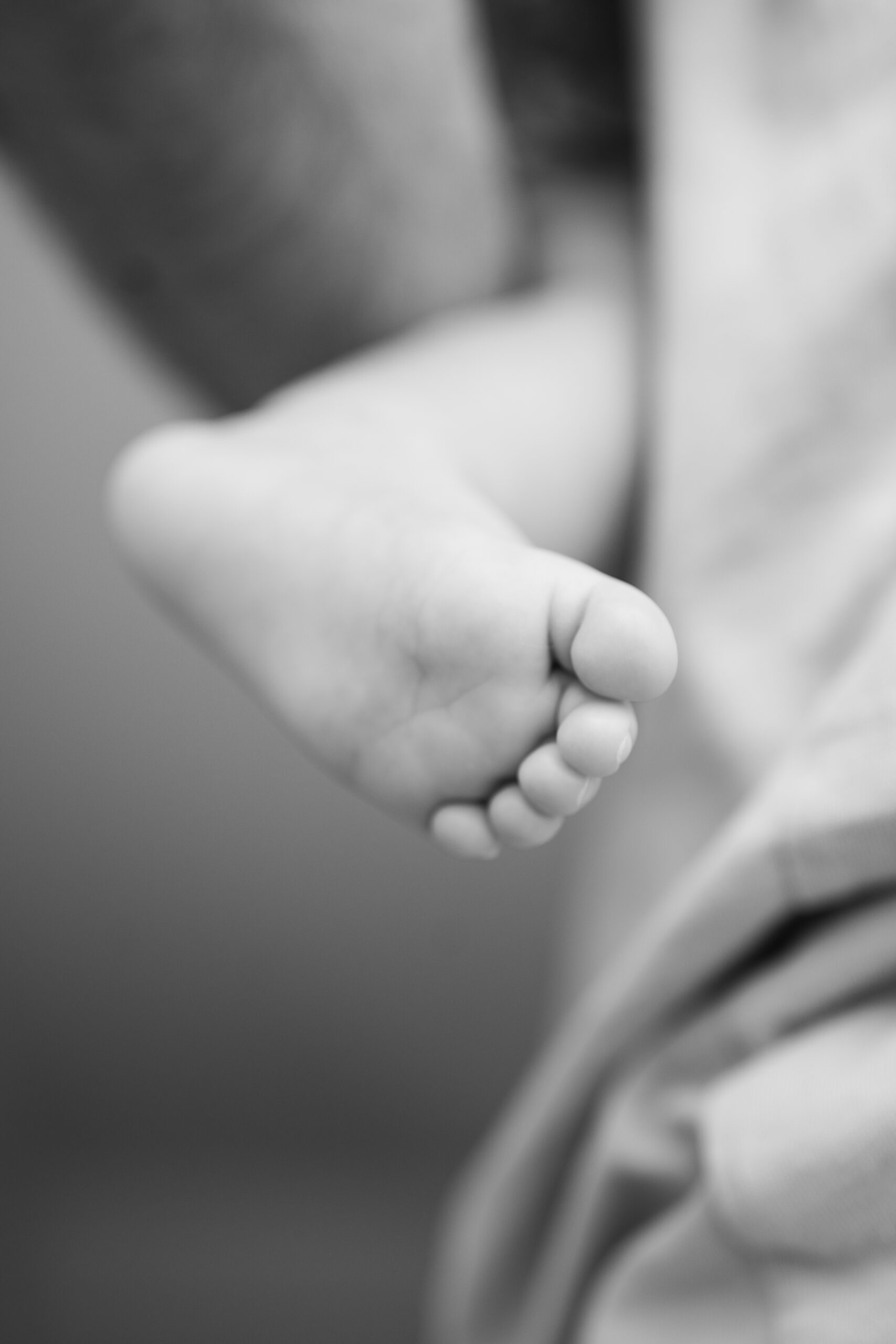 Detailfoto van voetje baby tijdens Newborn fotoshoot
